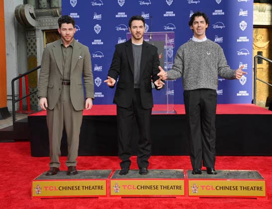 (L-R) Nick Jonas, Kevin Jonas and Joe Jonas of the Jonas Brothers participate in a hand and footprint ceremony immortalizing them in the forecourt of the TCL Chinese Theatre (formerly Grauman s) in the Hollywood section of Los Angeles on Wednesday, December 3, 2025.  LAP2025120312 JIMxRUYMEN