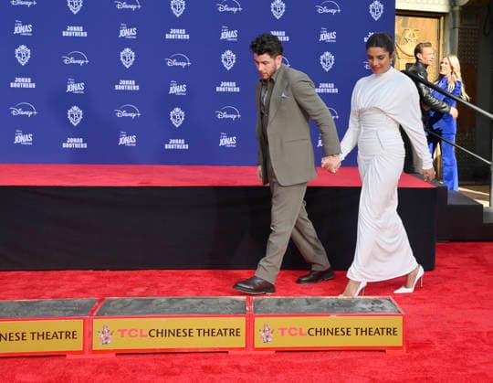 Nick Jonas is joined by his wife Priyanka Chopra at the Jonas Brothers hand and footprint ceremony immortalizing them in the forecourt of the TCL Chinese Theatre (formerly Grauman s) in the Hollywood section of Los Angeles on Wednesday, December 3, 2025.  LAP2025120317 JIMxRUYMEN