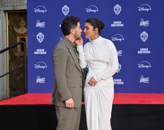 Nick Jonas is joined by his wife Priyanka Chopra at the Jonas Brothers hand and footprint ceremony immortalizing them in the forecourt of the TCL Chinese Theatre (formerly Grauman s) in the Hollywood section of Los Angeles on Wednesday, December 3, 2025.  LAP2025120323 JIMxRUYMEN