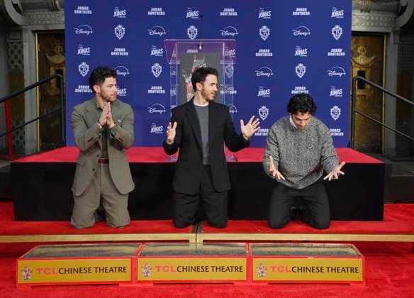 (L-R) Nick Jonas, Kevin Jonas and Joe Jonas of the Jonas Brothers participate in a hand and footprint ceremony immortalizing them in the forecourt of the TCL Chinese Theatre (formerly Grauman s) in the Hollywood section of Los Angeles on Wednesday, December 3, 2025.  LAP2025120310 JIMxRUYMEN