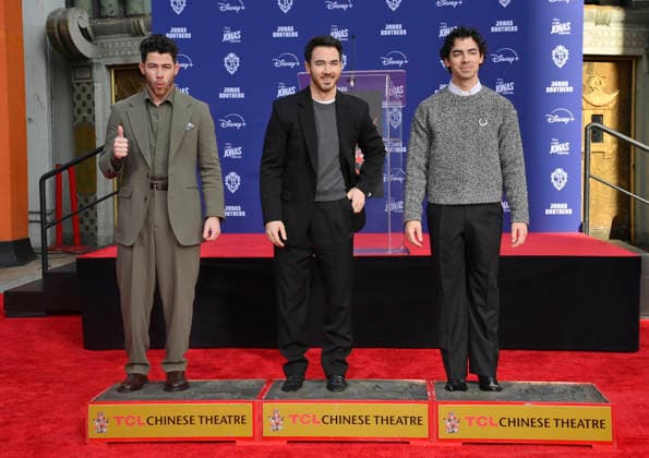 (L-R) Nick Jonas, Kevin Jonas and Joe Jonas of the Jonas Brothers participate in a hand and footprint ceremony immortalizing them in the forecourt of the TCL Chinese Theatre (formerly Grauman s) in the Hollywood section of Los Angeles on Wednesday, December 3, 2025.  LAP2025120313 JIMxRUYMEN