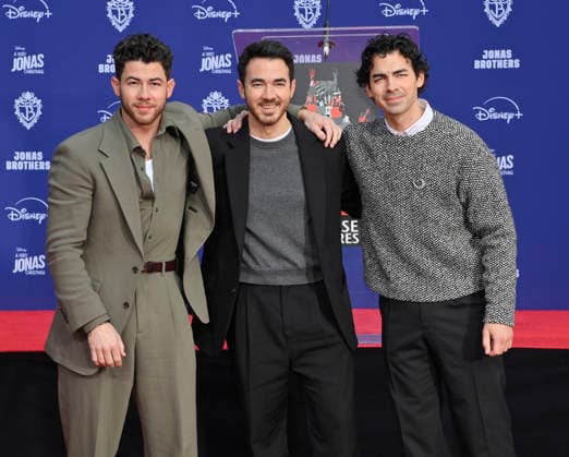 (L-R) Nick Jonas, Kevin Jonas and Joe Jonas of the Jonas Brothers participate in a hand and footprint ceremony immortalizing them in the forecourt of the TCL Chinese Theatre (formerly Grauman s) in the Hollywood section of Los Angeles on Wednesday, December 3, 2025.  LAP2025120314 JIMxRUYMEN