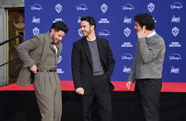 (L-R) Nick Jonas, Kevin Jonas and Joe Jonas of the Jonas Brothers participate in a hand and footprint ceremony immortalizing them in the forecourt of the TCL Chinese Theatre (formerly Grauman s) in the Hollywood section of Los Angeles on Wednesday, December 3, 2025.  LAP2025120315 JIMxRUYMEN