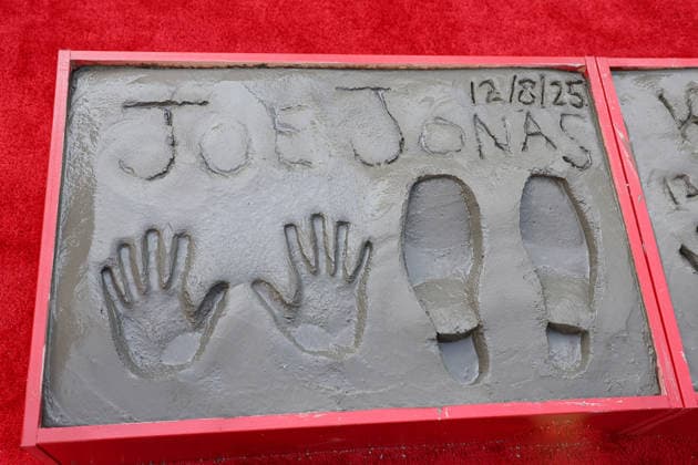 December 3, 2025, Los Angeles, California, USA: Joe Jonas prints at a ceremony honoring the Jonas Brothers with hand and foot prints at the TCL Chinese Theatre IMAX. Los Angeles USA - ZUMAg107 20251203_zep_g107_004 Copyright: xNinaxPrommerx
