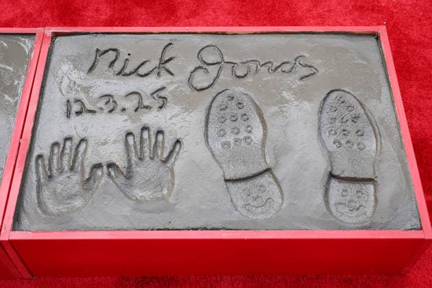 December 3, 2025, Los Angeles, California, USA: Nick Jonas prints at a ceremony honoring the Jonas Brothers with hand and foot prints at the TCL Chinese Theatre IMAX. Los Angeles USA - ZUMAg107 20251203_zep_g107_016 Copyright: xNinaxPrommerx