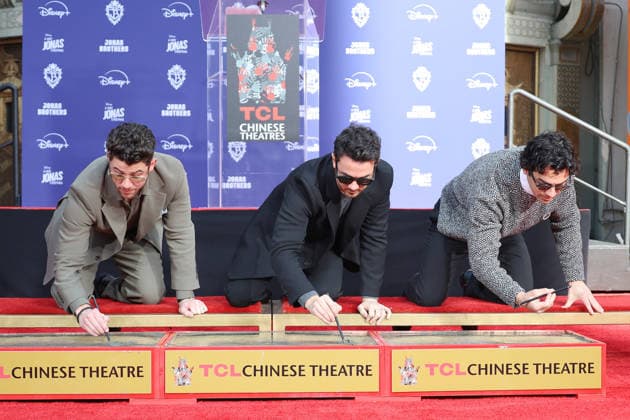 December 3, 2025, Los Angeles, California, USA: Nick Jonas, Kevin Jonas, Joe Jonas at a ceremony honoring the Jonas Brothers with hand and foot prints at the TCL Chinese Theatre IMAX. Los Angeles USA - ZUMAg107 20251203_zep_g107_017 Copyright: xNinaxPrommerx