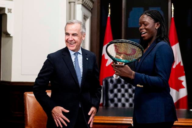 December 3, 2025, Ottawa, On, Canada: Prime Minister Mark Carney, left, reacts as Canadian tennis champion Victoria Mboko signs her tennis racket used to win the 2025 National Bank Open in Montreal during a meeting on Parliament Hill in Ottawa, on Wednesday, Dec. 3, 2025. Ottawa Canada  - ZUMAc35_ 20251203_zaf_c35_101 Copyright: xSpencerxColbyx