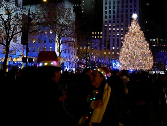 Revelers gather on the street after the Rockefeller Center Christmas Tree after it is lit for the first time of the season at the 93rd annual Rockefeller Center Christmas Tree lighting ceremony takes place in New York City on Wednesday, December 3, 2025. The 75-foot-tall Norway Spruce came from a home in East Greenbush, New York.  NYP20251203118 JOHNxANGELILLO