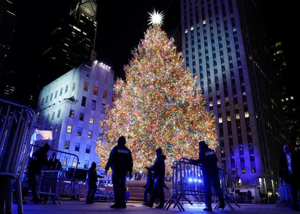 Workers and security guards place barricades around the Rockefeller Center Christmas Tree after it is lit for the first time of the season at the 93rd annual Rockefeller Center Christmas Tree lighting ceremony takes place in New York City on Wednesday, December 3, 2025. The 75-foot-tall Norway Spruce came from a home in East Greenbush, New York.  NYP20251203122 JOHNxANGELILLO