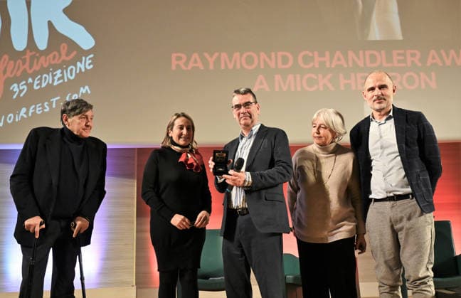 Milan, Italy Mick Herron receives the Raymond Chandler Award at the Noir in Festival with a masterclass at IULM In the photo: Mick Herron receives the Raymond Chandler Award at the Noir in Festival from Valentina Garavaglia, Rector of IULM University  Copyright: xNickxZonnax xipa-agency.netx xNickxZonnax IPA_Agency_IPA68737795