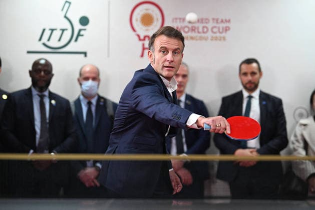 French President Emmanuel Macron meets French and Chinese players during the Mixed Team Table Tennis World Cup, including a greeting with the Lebrun brothers, as he is welcomed by spectators and takes part in a brief ping pong exchange, receiving a signed paddle and jersey, on Friday, December 5, during his state visit to China Jeanne Accorsini Pool Bestimage Chine  Copyright: xJeannexAccorsinix xPoolx xBestimagexJeannexAccorsinix xPoolx xBestimagex