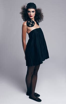 Portrait, woman and fashion in studio with confidence for vintage aesthetic, stylish dress and makeup. Female person, curls and beauty with accessories, unique clothes and style on gray background model released property released Copyright: xPeopleImages.comx-x 1374233x
