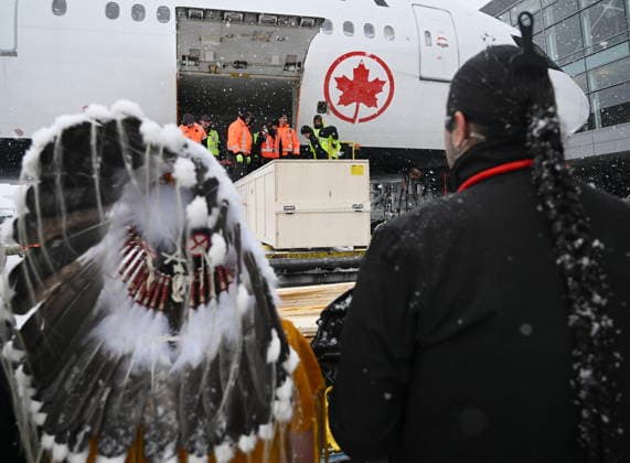 December 6, 2025, Montreal, Pq, Canada: Representatives from various First Nations look on as a kayak and other indigenous artifacts arrive at Trudeau Airport in Montreal, Saturday, December 6, 2025, after they were returned by the Vatican. Montreal Canada  - ZUMAc35_ 20251206_zaf_c35_047 Copyright: xGrahamxHughesx