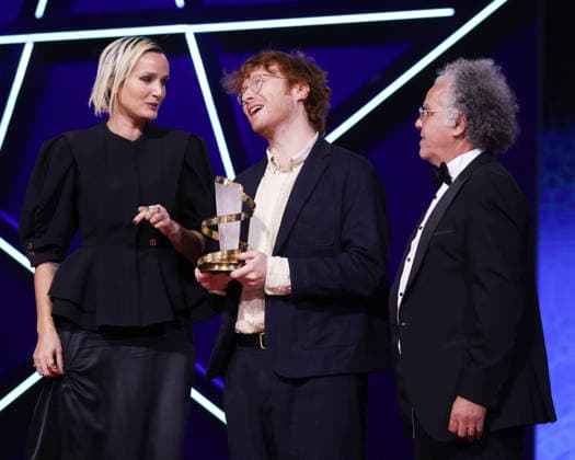L R Julia Ducournau, Oscar Hudson and Hakim Belabbes are seen on stage after receiving the Best Director Award for the film Straight Circle during the Closing Ceremony during the Closing Ceremony during the 22nd Marrakech International Film Festival Marrakech, Morocco 06 12 2025 451320 2025 12 06 MARRAKECH Morocco  Copyright: xRomualdxMeigneuxx xStarfacex STAR_451320_067