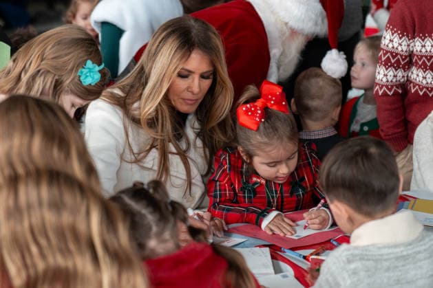 December 8, 2025, Quantico, Virginia, USA: A young girl sits on First Lady MELANIA TRUMPÃ¢â‚¬â ¢s lap as they make holiday cards together during a Toys for Tots event at Marine Corps Base Quantico. Quantico USA - ZUMAs365 20251208_znp_s365_003 Copyright: xJoeyxSussmanx