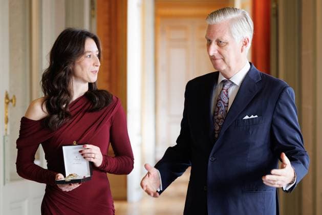Former gymnast Nina Derwael and King Philippe - Filip of Belgium pictured during a ceremony to award the Order of Leopold (Grootofficier in de Leopoldsorde - Grand Officier de l Ordre de Leopold) distinction, at the Royal Castle in Laken - Laeken, Brussels, on Tuesday 09 December 2025. Today the honorary order of knighthood is awarded to retired gymnast Derwael, the 2020 Olympic champion, two-time World champion, and three-time European champion.  BENOITxDOPPAGNE 147608535