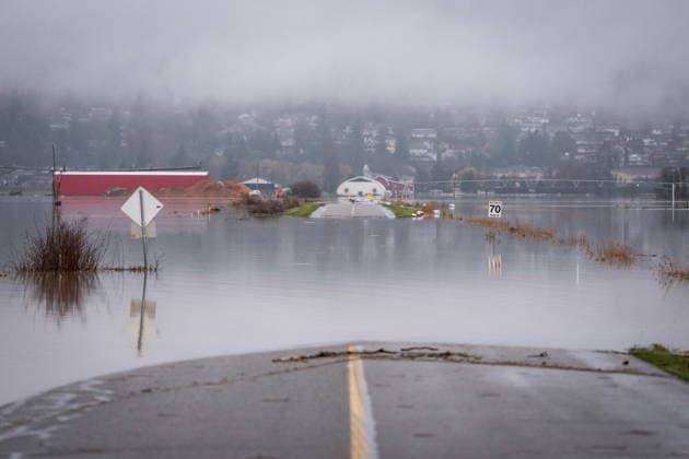 December 12, 2025, Abbotsford, Bc, CANADA: A road is covered by floodwaters in Abbotsford, B.C., Friday, Dec. 12, 2025. Abbotsford CANADA  - ZUMAc35_ 20251212_zaf_c35_045 Copyright: xEthanxCairnsx