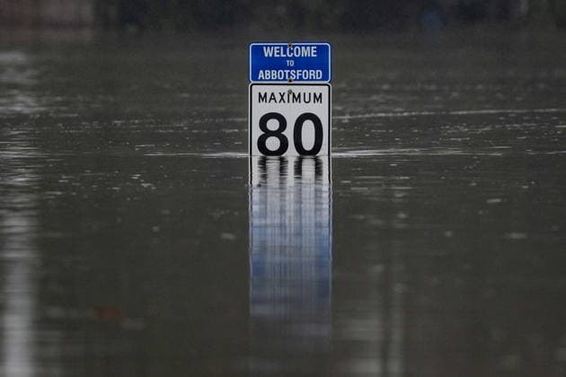 December 12, 2025, Abbotsford, Bc, CANADA: A Highway 1 speed limit sign pokes out from the floodwaters in Abbotsford, B.C., on Friday, Dec. 12, 2025. Abbotsford CANADA  - ZUMAc35_ 20251212_zaf_c35_057 Copyright: xEthanxCairnsx