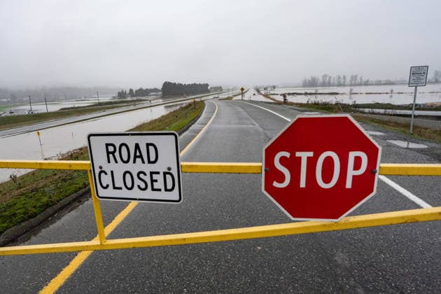 December 12, 2025, Abbotsford, Bc, CANADA: A gate blocks Highway 1 from traffic due to flooding in Abbotsford, B.C., on Friday, Dec. 12, 2025. Abbotsford CANADA  - ZUMAc35_ 20251212_zaf_c35_068 Copyright: xEthanxCairnsx