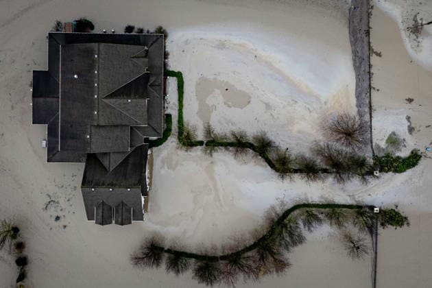 December 12, 2025, Abbotsford, Bc, CANADA: Floodwaters surround a house in Abbotsford, B.C., on Friday, Dec. 12, 2025. Abbotsford CANADA  - ZUMAc35_ 20251212_zaf_c35_071 Copyright: xEthanxCairnsx