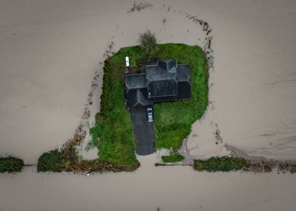 December 12, 2025, Abbotsford, Bc, CANADA: Floodwaters surround a house in Abbotsford, B.C., on Friday, Dec. 12, 2025. Abbotsford CANADA  - ZUMAc35_ 20251212_zaf_c35_072 Copyright: xEthanxCairnsx