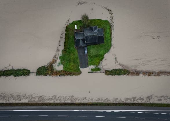 December 12, 2025, Abbotsford, Bc, CANADA: Floodwaters surround a house in Abbotsford, B.C., on Friday, Dec. 12, 2025. Abbotsford CANADA  - ZUMAc35_ 20251212_zaf_c35_073 Copyright: xEthanxCairnsx