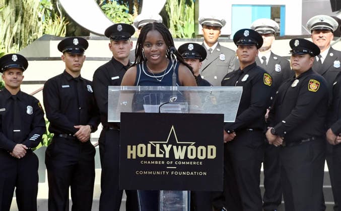 Eniola Taiwo (C) participates in an unveiling ceremony honoring the Los Angeles Fire Department with an Award of Excellence star adjacent to the Hollywood Walk of Fame in Los Angeles on Tuesday, December 2, 2025. Taiwo, 14, wrote a letter to the Hollywood Chamber of Commerce suggesting that firefighters who battled the deadly January fires were worthy of a star on the Hollywood Walk of Fame. The letter precipitated the tribute.  LAP2025121217 JIMxRUYMEN