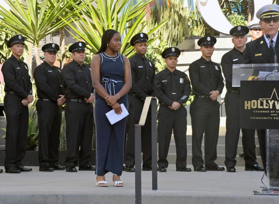 Eniola Taiwo (C) participates in an unveiling ceremony honoring the Los Angeles Fire Department with an Award of Excellence star adjacent to the Hollywood Walk of Fame in Los Angeles on Tuesday, December 2, 2025. Taiwo, 14, wrote a letter to the Hollywood Chamber of Commerce suggesting that firefighters who battled the deadly January fires were worthy of a star on the Hollywood Walk of Fame. The letter precipitated the tribute.  LAP2025121219 JIMxRUYMEN