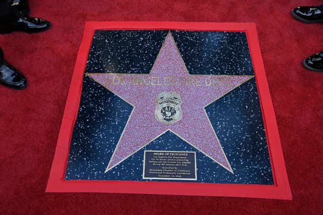 The Award of Excellence star adjacent to the Hollywood Walk of Fame is seen during an unveiling ceremony honoring the Los Angeles Fire Department with an Award of Excellence star adjacent to the Hollywood Walk of Fame in Los Angeles on Tuesday, December 2, 2025. Eniola Taiwo, 14, wrote a letter to the Hollywood Chamber of Commerce suggesting that firefighters who battled the deadly January fires were worthy of a star on the Hollywood Walk of Fame. The letter precipitated the tribute.  LAP2025121223 JIMxRUYMEN