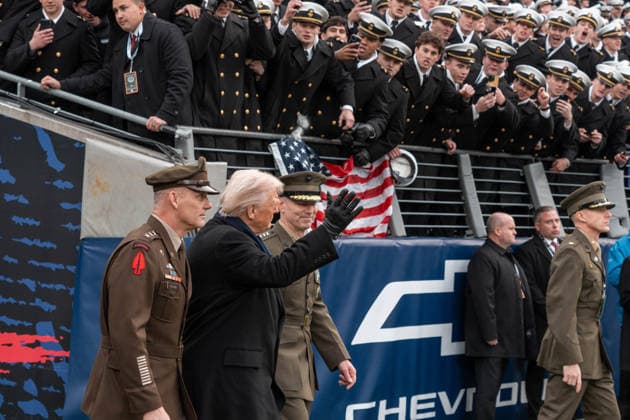 December 13, 2025, Baltimore, Maryland, USA: President DONALD TRUMP waves to a crowd of Midshipmen as he walks out onto the field accompanied by Army and Marine officers. Baltimore USA - ZUMAs365 20251213_znp_s365_001 Copyright: xJoeyxSussmanx