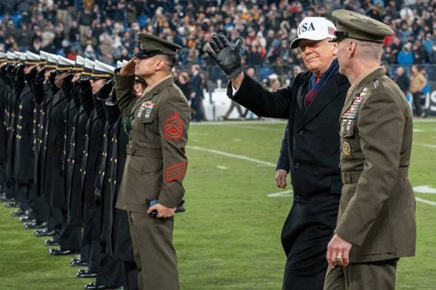 December 13, 2025, Baltimore, Maryland, USA: President DONALD TRUMP waves to the crowd as he walks toward a row of members of the military saluting. Baltimore USA - ZUMAs365 20251213_znp_s365_006 Copyright: xJoeyxSussmanx