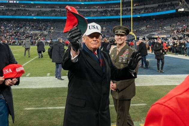 December 13, 2025, Baltimore, Maryland, USA: President DONALD TRUMP holds up a hat as he looks into the stands before throwing it at the Army Navy Football Game. Baltimore USA - ZUMAs365 20251213_znp_s365_008 Copyright: xJoeyxSussmanx