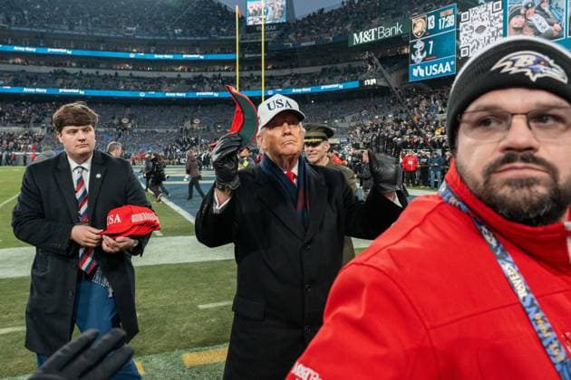 December 13, 2025, Baltimore, Maryland, USA: President DONALD TRUMP holds up a hat as he looks into the stands before throwing it at the Army Navy Football Game. Baltimore USA - ZUMAs365 20251213_znp_s365_009 Copyright: xJoeyxSussmanx