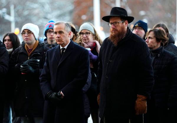 December 14, 2025, Ottawa, On, CAN: Prime Minister Mark Carney stands with Rabbi Chaim Boyarsky of the Chabad Student Network of Ottawa, as he participates in the lighting of the menorah at City Hall in Ottawa to celebrate Hanukkah and show solidarity with the Jewish community in the aftermath of a deadly shooting at an event in Sydney, Australia, on Sunday, Dec. 14, 2025. Ottawa CAN  - ZUMAc35_ 20251214_zaf_c35_005 Copyright: xJustinxTangx