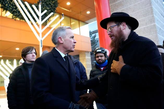 December 14, 2025, Ottawa, On, CAN: Prime Minister Mark Carney speaks with Rabbi Chaim Boyarsky of the Chabad Student Network of Ottawa, after the lighting of the menorah at City Hall in Ottawa to celebrate Hanukkah in the aftermath of a deadly shooting at an event in Sydney, Australia, on Sunday, Dec. 14, 2025. Ottawa CAN  - ZUMAc35_ 20251214_zaf_c35_006 Copyright: xJustinxTangx