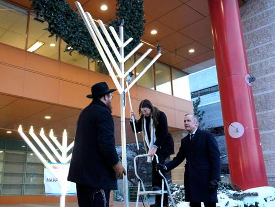 December 14, 2025, Ottawa, On, CAN: Prime Minister Mark Carney holds a stepladder for Olivia Mellcovsky, as she lights the menorah at City Hall in Ottawa to celebrate Hanukkah, in the aftermath of a deadly shooting at a Jewish event in Sydney, Australia, on Sunday, Dec. 14, 2025. Ottawa CAN - ZUMAc35_ 20251214_zaf_c35_007 Copyright: xJustinxTangx