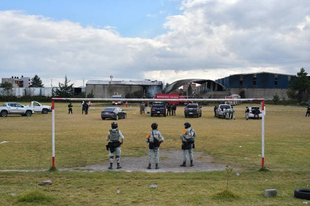 (251215) -- TOLUCA, Dec. 15, 2025 -- Members of the National Guard keep watch at the aircraft crash site in Toluca, the State of Mexico, central Mexico, Dec. 15, 2025. At least six people were killed Monday after a small aircraft crashed in the municipality of San Mateo Atenco in Mexico s central State of Mexico, local authorities said. (Photo by Xinhua) MEXICO-STATE OF MEXICO-TOLUCA-AIRCRAFT-CRASH ArturoxHernandez 