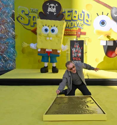 Tom Kenny, the voice of SpongeBob participates in a hand and footprint ceremony immortalizing SpongeBob in the forecourt of the TCL Chinese Theatre (formerly Grauman s) in the Hollywood section of Los Angeles on Tuesday, December 16, 2025.  LAP20251216400 JIMxRUYMEN
