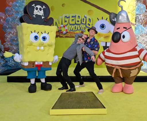 Tom Kenny, the voice of SpongeBob (L) and and Bill Fagerbake, the voice of Patrick participate in a hand and footprint ceremony immortalizing SpongeBob in the forecourt of the TCL Chinese Theatre (formerly Grauman s) in the Hollywood section of Los Angeles on Tuesday, December 16, 2025.  LAP20251216411 JIMxRUYMEN