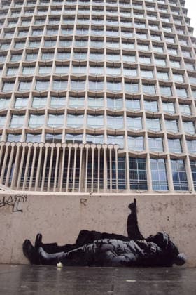 December 21, 2025, London, England, United Kingdom: A new artwork, suspected to be by elusive street artist Banksy, has appeared outside Centre Point and Tottenham Court Road Station. The artwork depicts two children lying on their backs and pointing upwards. The artwork has not yet been confirmed as a genuine Banksy. London United Kingdom - ZUMAv130 20251221_zip_v130_002 Copyright: xVukxValcicx