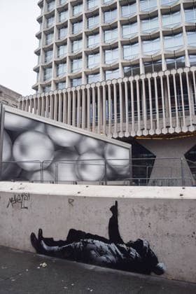 December 21, 2025, London, England, United Kingdom: A new artwork, suspected to be by elusive street artist Banksy, has appeared outside Centre Point and Tottenham Court Road Station. The artwork depicts two children lying on their backs and pointing upwards. The artwork has not yet been confirmed as a genuine Banksy. London United Kingdom - ZUMAv130 20251221_zip_v130_005 Copyright: xVukxValcicx