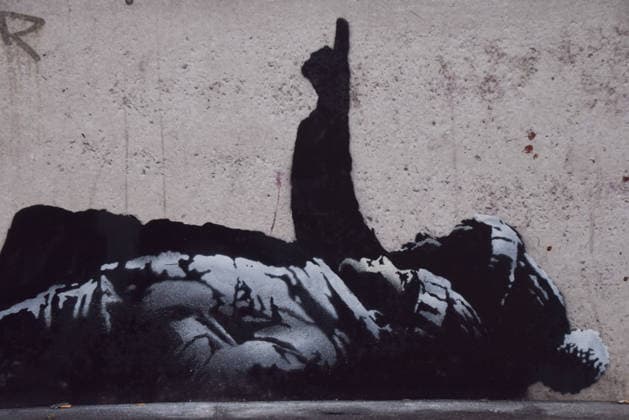 December 21, 2025, London, England, United Kingdom: A new artwork, suspected to be by elusive street artist Banksy, has appeared outside Centre Point and Tottenham Court Road Station. The artwork depicts two children lying on their backs and pointing upwards. The artwork has not yet been confirmed as a genuine Banksy. London United Kingdom - ZUMAv130 20251221_zip_v130_006 Copyright: xVukxValcicx