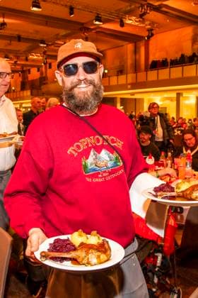 abb Rapper MC Fitti as celebrity waiter serving plates with Gaensekeuele red cabbage and dumplings at the 31 Frank Zander Christmas party Christmas dinner for homeless and needy people 2025 at Estrel Convention Center on December 22, 2025 in Berlin Berlin Germany