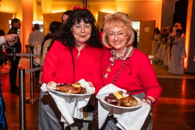 abb Heike Koefer and Stefanie Simon as celebrity waiters serving plates with Gaensekeuele red cabbage and dumplings at the 31 Frank Zander Christmas Party Christmas Dinner for Homeless and Needy People 2025 at Estrel Convention Center on December 22, 2025 in Berlin Berlin Germany