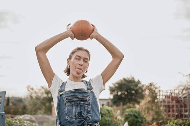 Smiling person on allotment holding pumpkin on head in London model released, Symbolfoto property released, PWF01549