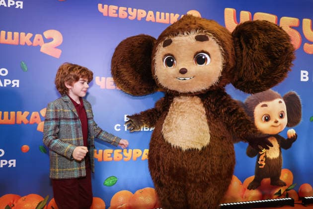 RUSSIA, MOSCOW - DECEMBER 24, 2025: Actor Ilya Kondratenko poses with an artist cosplaying the title character on the red carpet during the premiere of the family comedy Cheburashka 2 by Dmitry Dyachenko at the KARO 11 Oktyabr cinema on Novy Arbat Street (New Arbat Avenue). Valery Sharifulin TASS  86692118