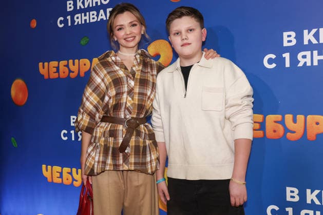 RUSSIA, MOSCOW - DECEMBER 24, 2025: Actress Olga Kuzmina poses with her son Gordey on the red carpet during the premiere of the family comedy Cheburashka 2 by Dmitry Dyachenko at the KARO 11 Oktyabr cinema on Novy Arbat Street (New Arbat Avenue). Valery Sharifulin TASS  86692612