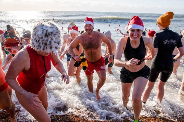 December 25, 2025, Brighton, United Kingdom: Swimmers seen during the traditional Christmas Day swim at Brighton Beach. Members of the public took part in the annual Christmas Day swim held at Brighton Beach, East Sussex, England. Originally established by the Brighton Swimming Club in 1860, this event is regarded as one of the oldest festive swims in England. On the morning of Christmas Eve, swimmers arrived with some dressed in festive seasonal outfits to enter the water at 11:00 a.m. Brighton United Kingdom - ZUMAs197 20251225_aab_s197_022 Copyright: xJamesxWilloughbyx