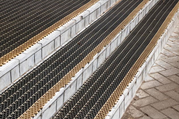 Creative Highlights World Close up of stairs with a black and gold mat on them This image features a closeup view of a staircase that is adorned with an elegant black and gold mat placed gracefully on the steps, 96736202.jpg RECORD DATE NOT STATED