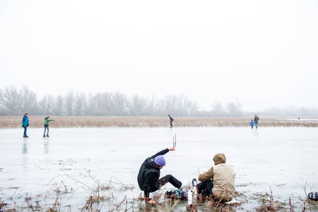 December 27, 2025, Nijmegen, Netherlands: A woman is trying to get up with the ice skaters on. After several days of sub-zero temperatures during the night, the water of some lakes started to freeze over. People took the chance to skate on one of the frozen lakes close to the Dutch city of Nijmegen. It takes at least four whole days of below-freezing temperatures to form ice that™s safe to walk and skate on, and that only applies to ponds or lakes with no currents. Nijmegen Netherlands - ZUMAs197 20251227_aab_s197_056 Copyright: xAnaxFernandezx
